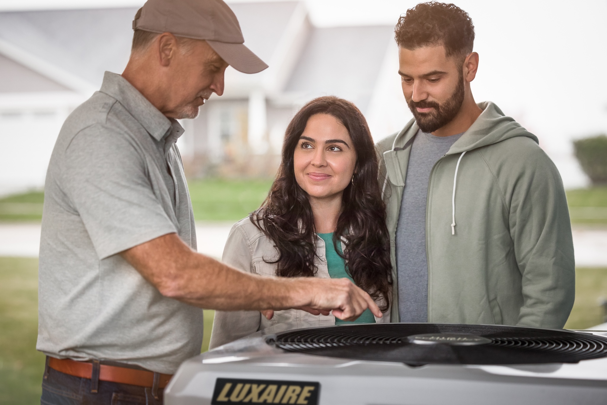 HVAC technician explaining system to homeowners